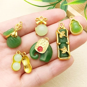Detail of Chinese style jade pendants including lotus seed pod and lucky bag designs