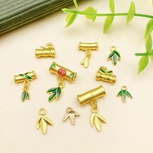 Detail of bamboo pendants with green enamel and Fu character for jewelry making
