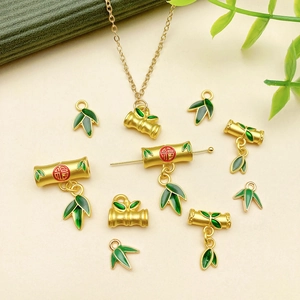 Bamboo-themed gold jewelry pendants with green enamel and Fu character ornaments