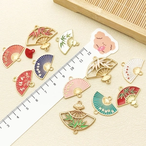 Detail view of colorful Chinese fan pendants with enamel finish and lucky characters