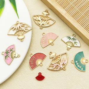 Detailed macro view of Chinese style enamel bamboo leaf fan pendants for DIY jewelry