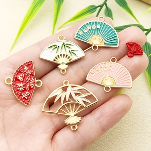 Traditional Chinese style fan charms with bamboo leaf and auspicious red enamel design