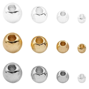 Round metal beads with spiral texture in gold, silver, and black for DIY jewelry making