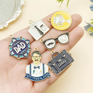 Detail of Father's Day enamel charms including shirt and briefcase for DIY keychains