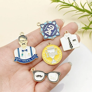 Detail of Father's Day alloy charms featuring shirt, trophy and medal designs for DIY crafts