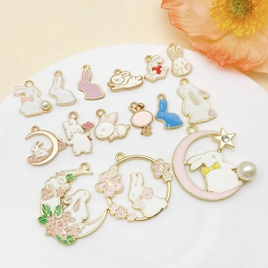 Detailed flat lay of cute bunny moon charms and heart charms for DIY jewelry making