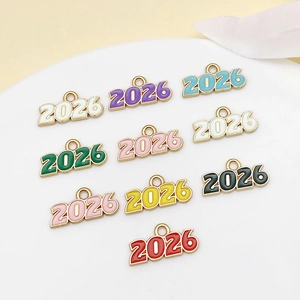 Colorful 2026 enamel year pendants for DIY jewelry making on white display plate