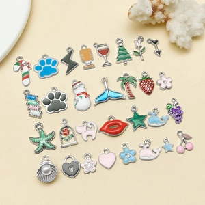 Flat lay of colorful enamel alloy charms with snowman and palm tree for DIY jewelry making