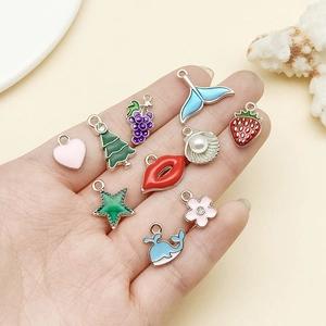 Detailed set of 10 colorful enamel charms featuring stars, hearts and fruit for DIY jewelry
