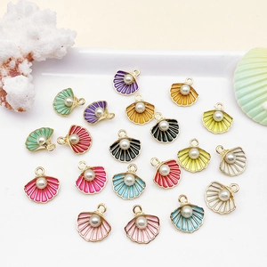 Colorful enamel shell pendants with pearls for DIY jewelry making on white tray