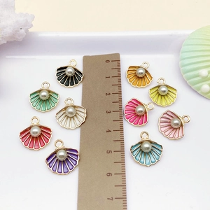 Detail view of colorful enamel shell charms with pearls for DIY jewelry making