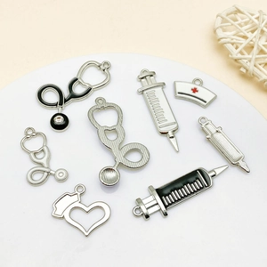 Macro shot of assorted medical charms including stethoscopes and nurse hats for DIY jewelry