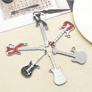 Detail of six assorted enamel guitar pendants in red, black and silver for DIY jewelry