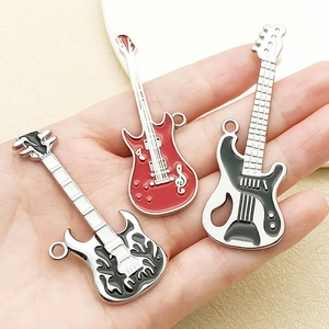 Three hip hop guitar pendants in red and black with detailed flame and musical note patterns