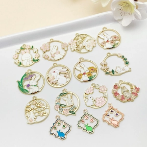 Close-up of colorful enamel bunny and cherry blossom pendants for DIY jewelry