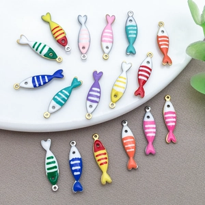 Macro shot of colorful striped fish charms made of stainless steel enamel for DIY jewelry