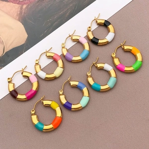 Flat lay of retro stainless steel enamel bamboo hoop earrings in assorted vibrant colors
