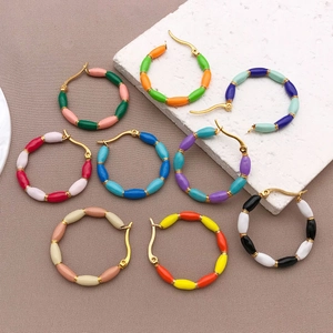 Detailed view of colorful enamel bead bamboo earrings in gold stainless steel finish