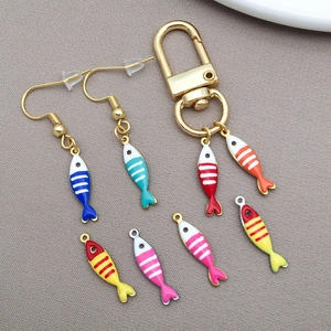 Detailed view of colorful striped enamel fish charms for DIY jewelry and necklaces