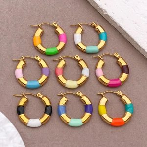 Detail showing various colors of bamboo-style gold hoop earrings with enamel finish