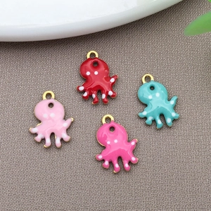 Macro shot of colorful enamel octopus charms with golden loops for DIY jewelry making