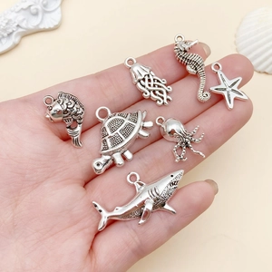 Macro detail of antique silver ocean themed charms featuring starfish and sea creatures