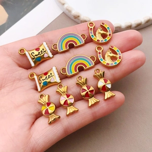 Macro detail of DIY colorful enamel rainbow and bull head pendants for jewelry making