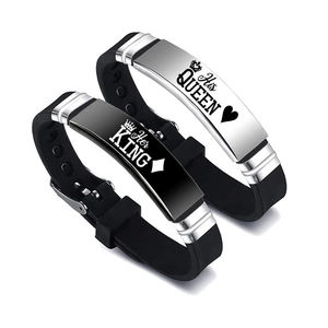 Detail of King and Queen crown engraving on stainless steel and silicone couple bracelets