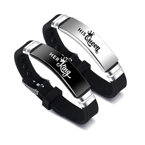 Detail view of His Queen and Her King crown engravings on couple silicone bracelets