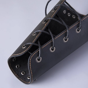 Minimalist black leather wrist guard with yellow stitching and lace-up closure for cycling