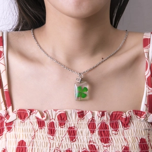 Handmade clear resin necklace with real four-leaf clover pendant and silver wish tag