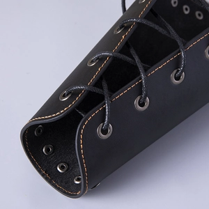 Detail of black leather bracer with orange stitching and adjustable lace-up metal eyelets