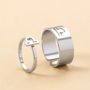 Detailed macro of Libra zodiac couple rings with minimalist open adjustable band design