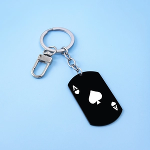 Macro view of stainless steel Ace of Spades dog tag keychain with silver lobster clasp