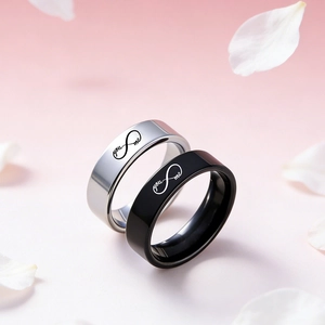Detail of couple rings with infinity symbol and you and me engraving on metal
