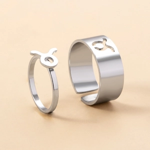Detail of silver Taurus zodiac couple rings with minimalist adjustable open bands