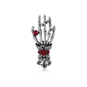 Gothic skull hand brooch in vintage silver with red rhinestones and leaf design