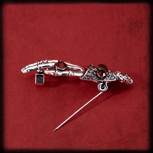 Vintage punk silver skeleton hand brooch with red and white rhinestones and pin closure