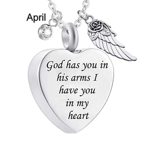 Detail of heart pendant with angel wing and April birthstone on a silver chain