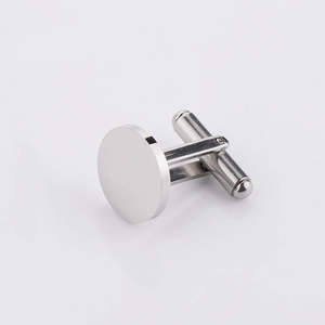 Close-up of a polished round stainless steel cufflink with T-shaped rotating mechanism