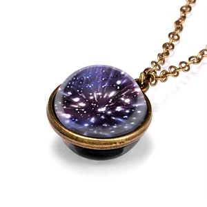 Macro shot of vintage galaxy pendant with purple nebula design in a bronze frame