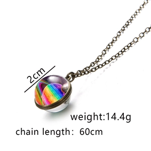 Close-up of galaxy nebula glass pendant with 2cm diameter and 60cm bronze chain