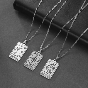 Three tarot card necklaces in stainless steel featuring Star, Fortune, and World designs