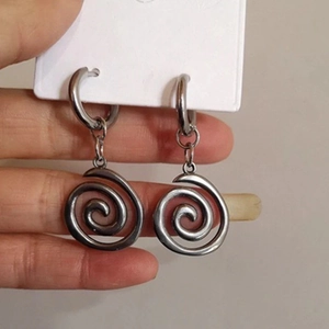 Detailed view of silver spiral dangle earrings with minimalist hoop design for women