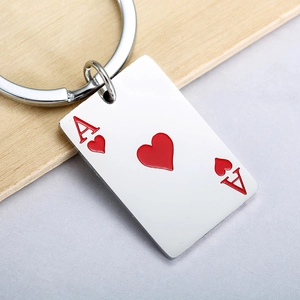 Detail of Ace of Hearts poker card keychain in polished silver metal with red engraving