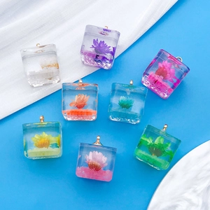 Colorful resin cube pendants with dried flowers and golden eyelet hooks for DIY jewelry