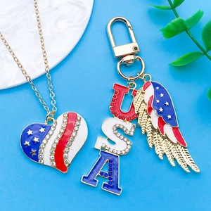 Detail of USA heart necklace and wing keychain with red white blue enamel finish