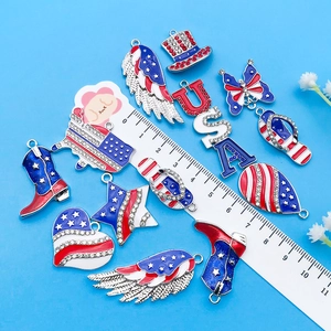 Macro detail of USA theme enamel pendants with rhinestones next to a measuring ruler