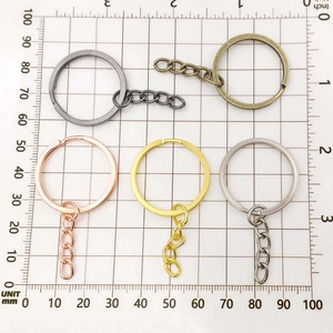 Detailed close-up of 30mm flat key rings with chains in five plating colors for DIY crafts