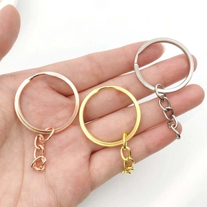 Detail view of gold, silver, and rose gold metal split key rings with small chain links